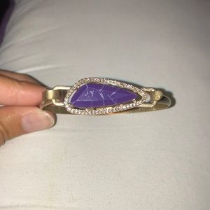 Gold bracelet with purple stone